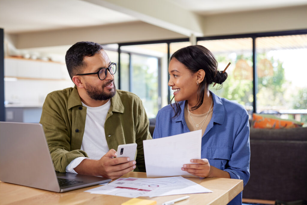 Couple discussing home finance while checking bills